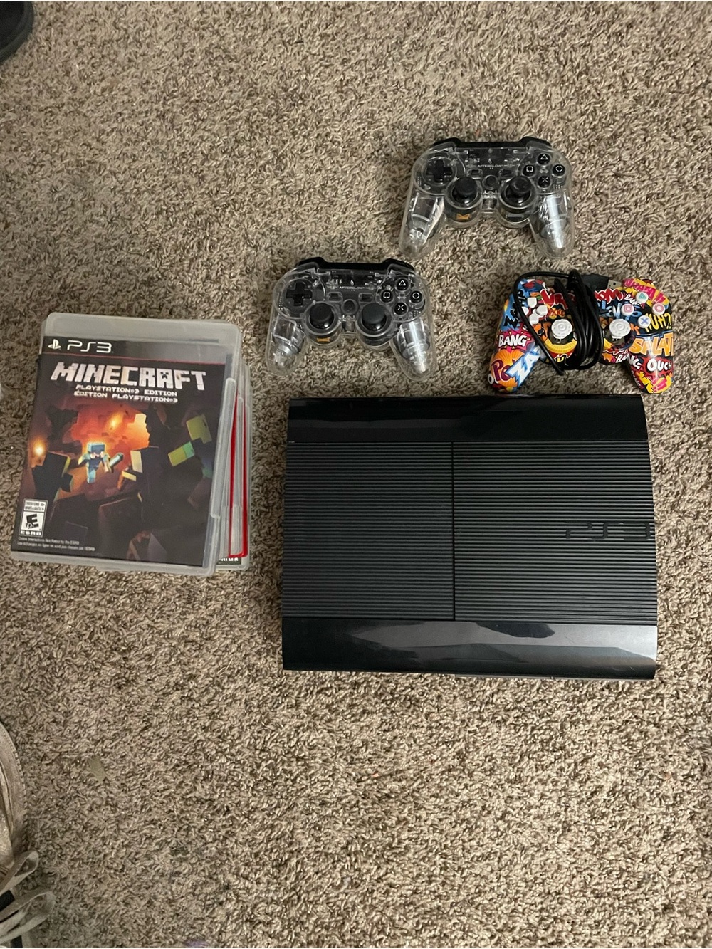 Sony Black PS3 Super Slim Console with Clear and Multicolor Controllers